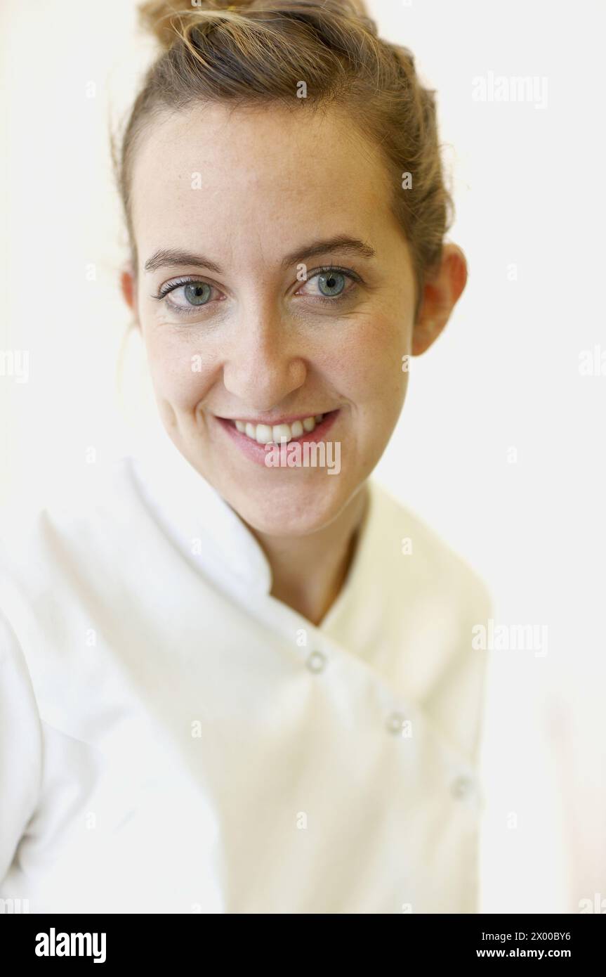 Portrait of woman in white coat Stock Photo - Alamy