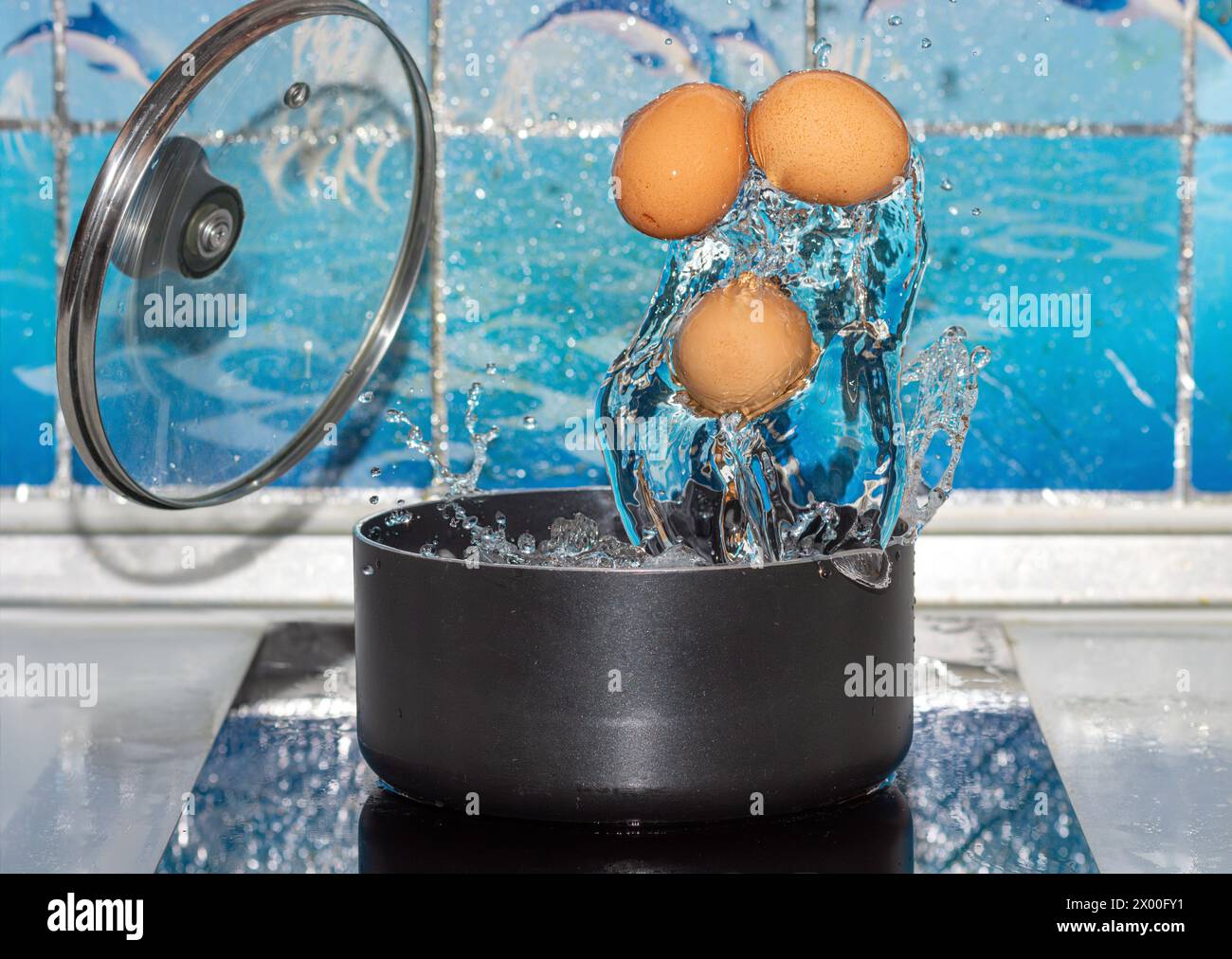 Eggs are boiled in a pot on the stove Stock Photo