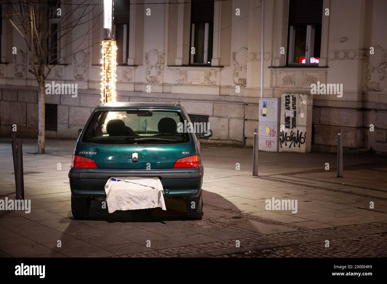 Picture of a car illegally parked on the sidewalk of belgrade city center with a covered and hidden licence plate in an attempt to avoid paying the fi Stock Photo