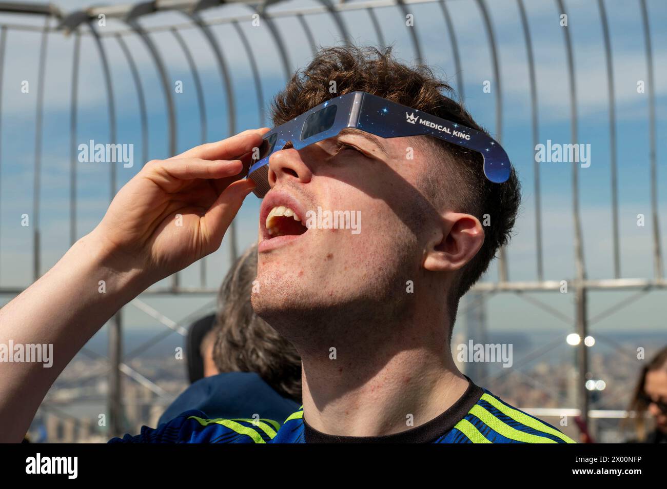 New York, New York, USA. 8th Apr, 2024. (NEW) Solar Eclipse 2024 in New York City. April 08, 2024, New York, New York, USA: A boy wearing protective glasses views the partial solar eclipse from the 86th floor Observation deck of the Empire State Building on April 8, 2024 in New York City. With the first solar eclipse to pass through North America in seven years, New York City was not in the path of totality, with only 90% of the sun covered by the moon; the next eclipse visible in the United States will be in 2044. (Credit: M10s/TheNews2) (Foto: M10s/Thenews2/Zumapress) (Credit Ima Stock Photo