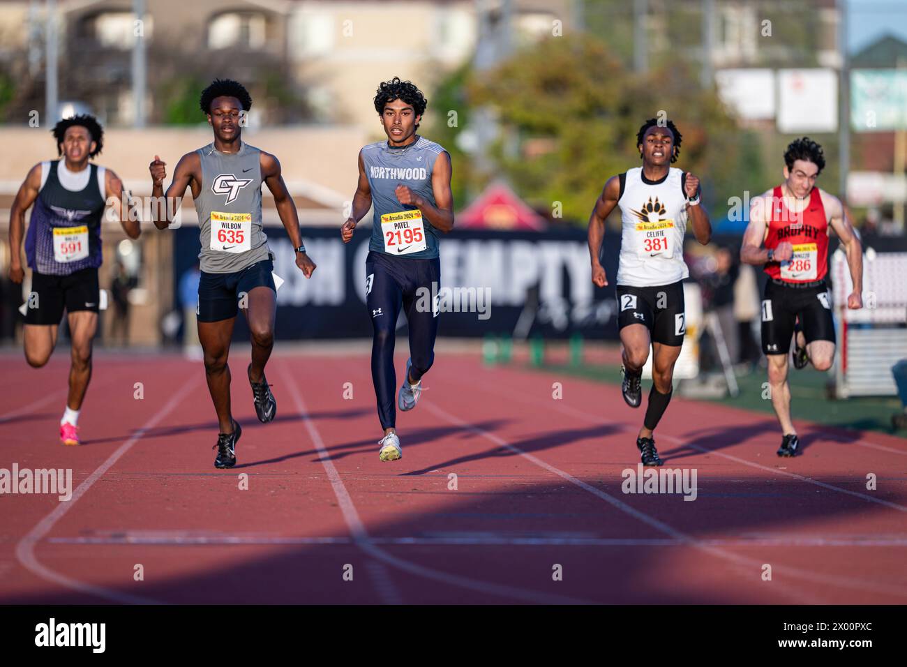 Dheer Patel of Northwood (center) wins the seeded 400 meter dash in 48.