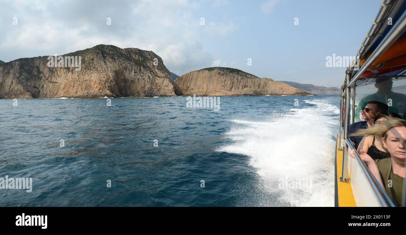 A boat trip along the rugged coastal landscapes in Sai Kung East Country park in Hong Kong. Stock Photo