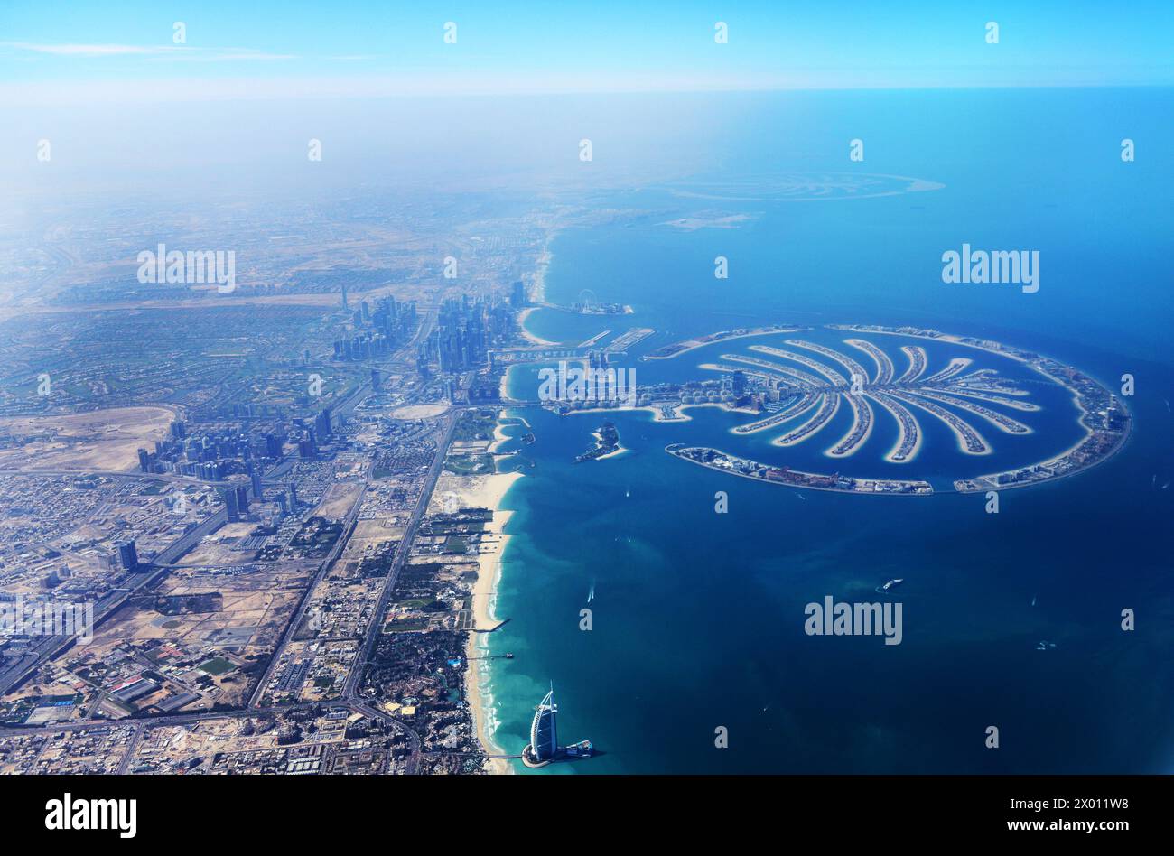 An Aerial view of Dubai's coastline with the Burj Al Arab hotel and the  Palm Jumeirah islands. Dubai, UAE. Stock Photo