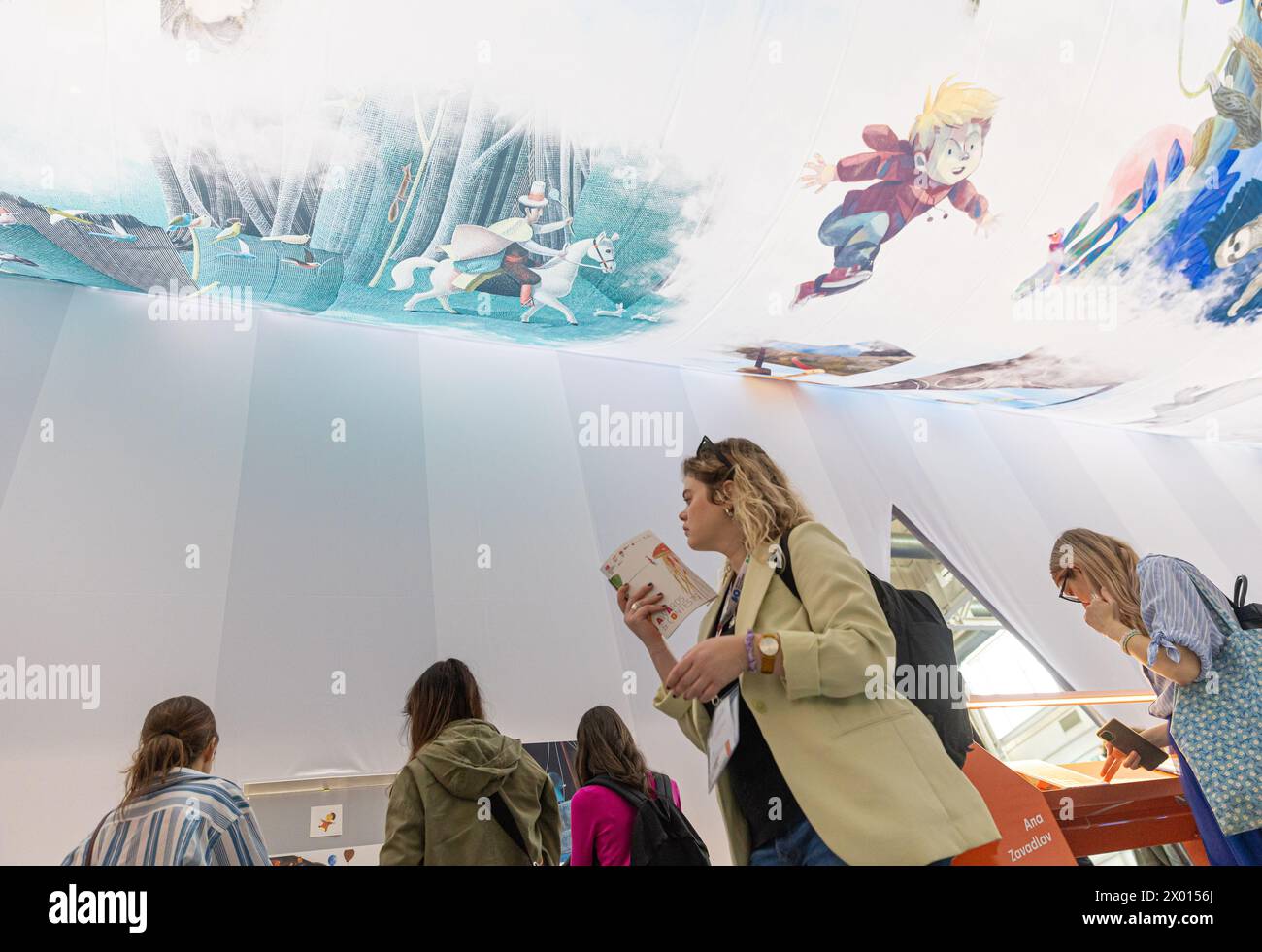 Bologna, Italy. 8th Apr, 2024. People visit the Bologna Children's Book Fair at Bologna Fiere Center, in Bologna, Italy, April 8, 2024. The 61st Bologna Children's Book Fair kicked off on Monday with the participation of 1,500 exhibitors from about 100 countries and regions of the world. The fair will last until April 11. Credit: Li Jing/Xinhua/Alamy Live News Stock Photo