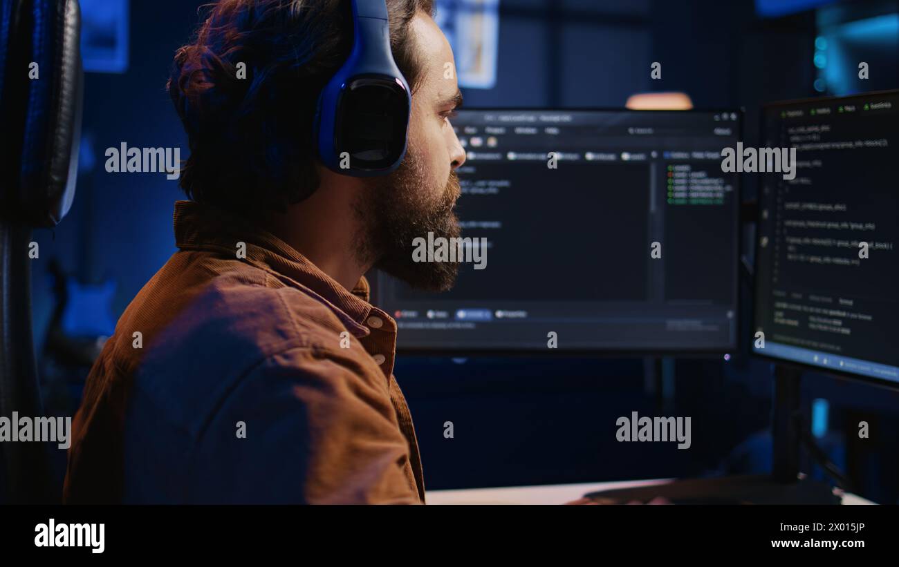 Developer listening music and drinking coffee while doing programming ...