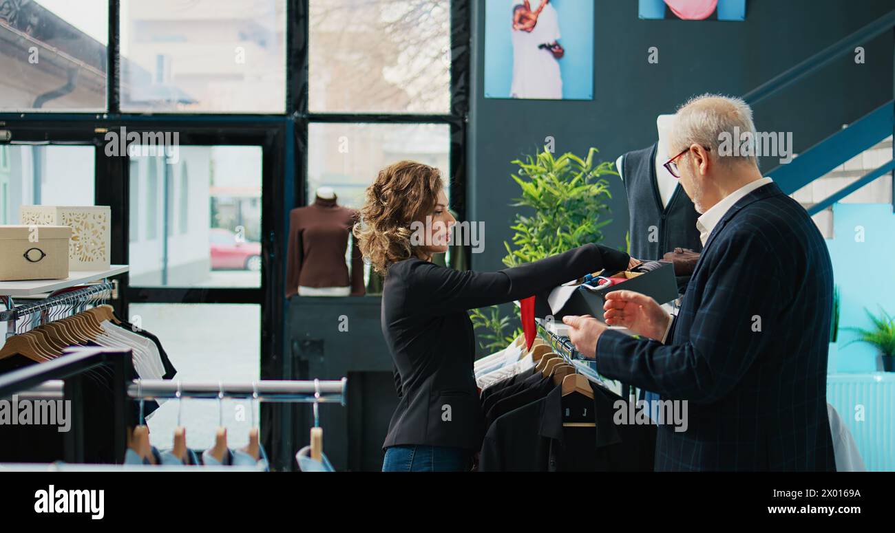 Woman employee presenting formal accessories to regular client ...