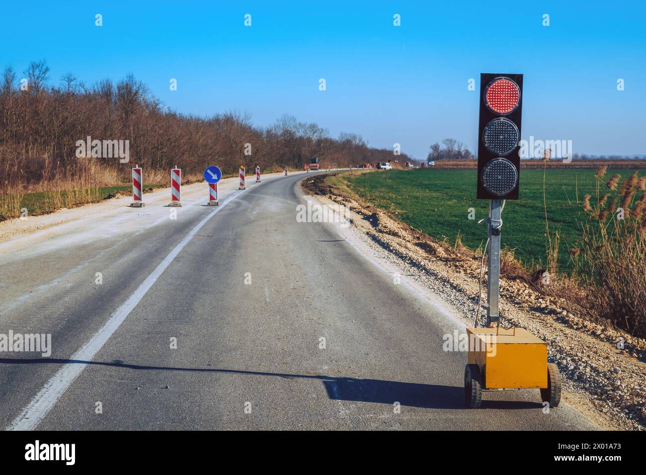 Traffic light signalization during road maintenance, red stoplight for traffic regulation, selective focus Stock Photo