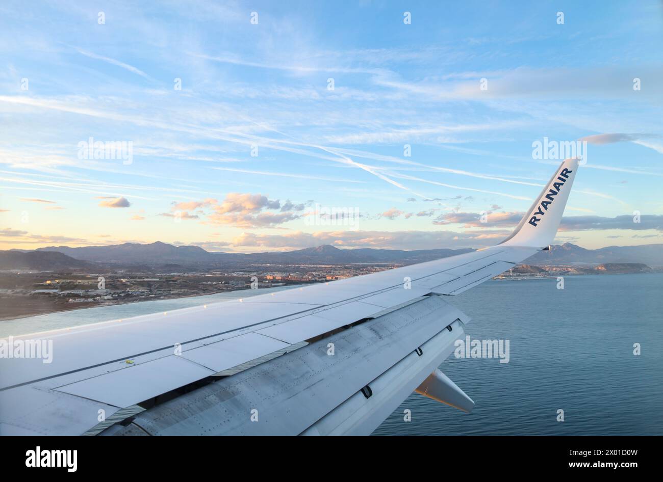 Alicante, Spain- March 28, 2024: Ryanair company plane flying over the Mediterranean coast of Alicante, Spain Stock Photo