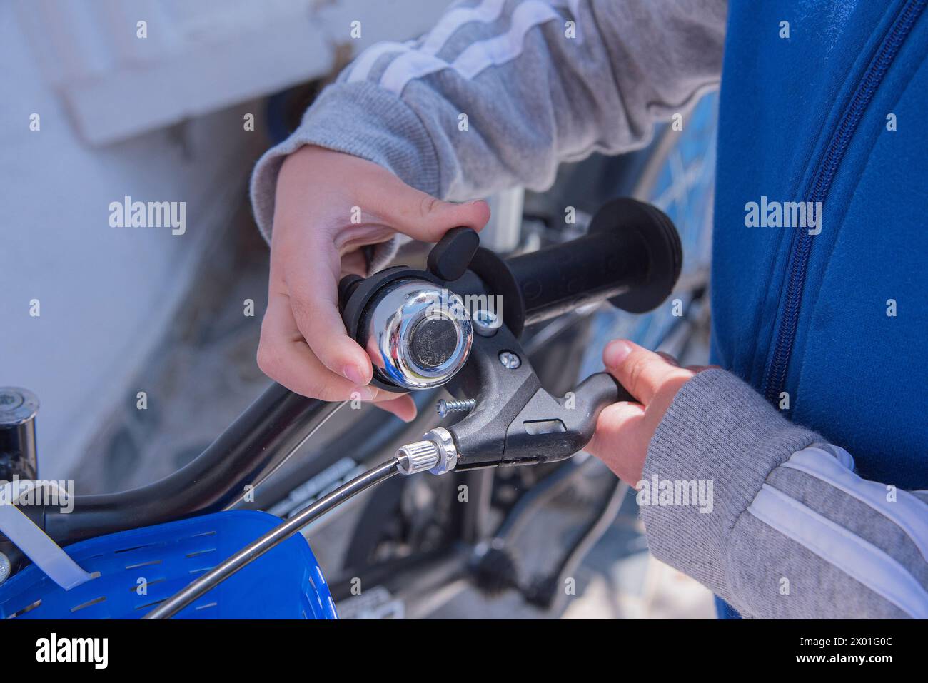 Child ringing bell on bike Stock Photo - Alamy