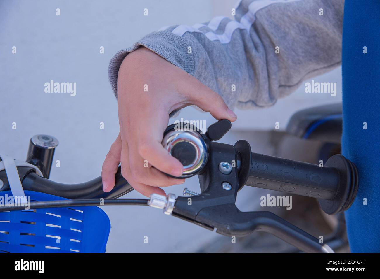 Child ringing bell on bike Stock Photo - Alamy