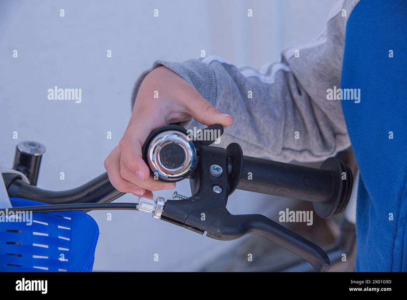 Child ringing bell on bike Stock Photo - Alamy