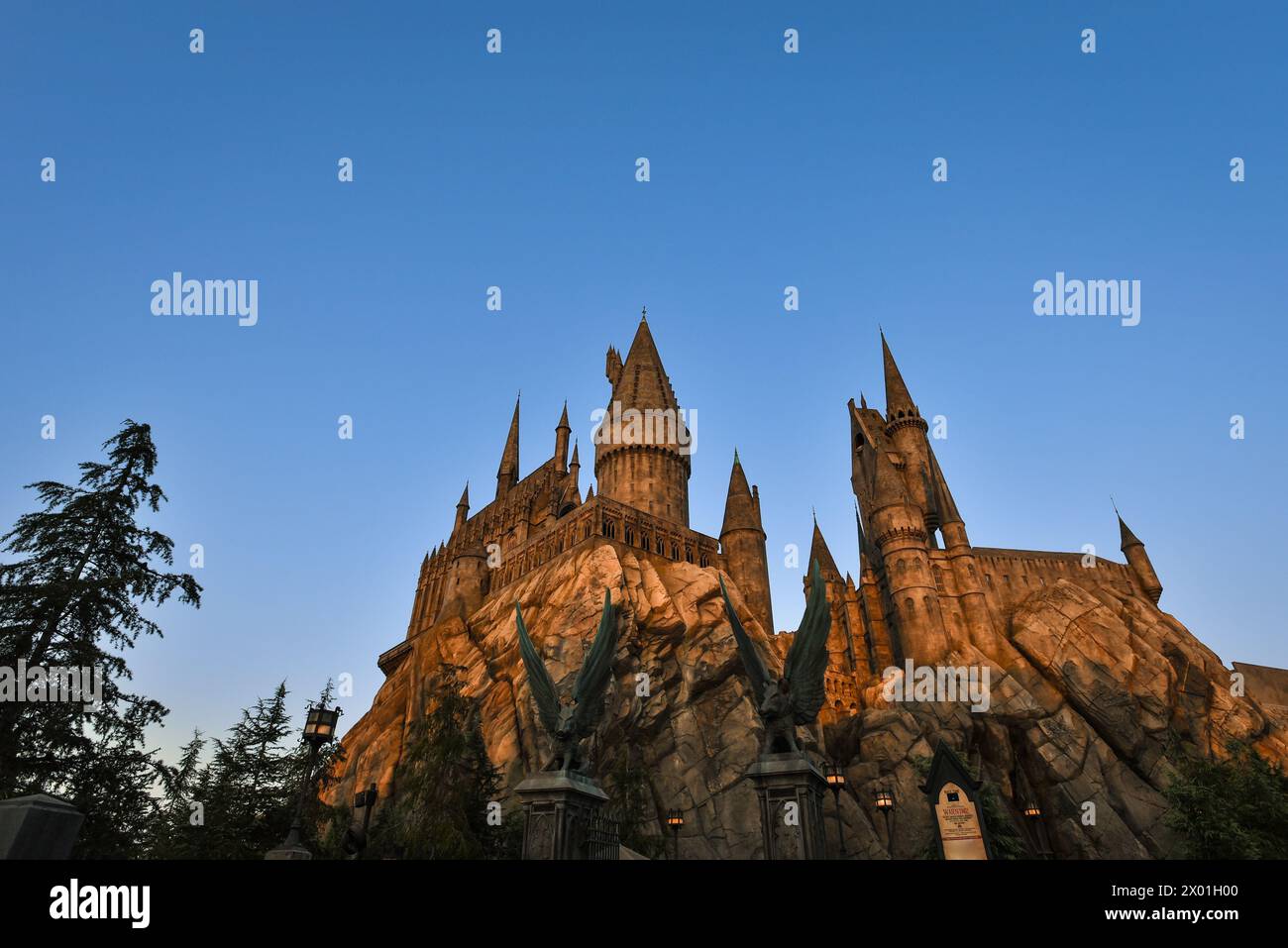 Sunset over Hogwarts Castle at the Wizarding World of Harry Potter in Universal Studios Hollywood - Los Angeles, California Stock Photo