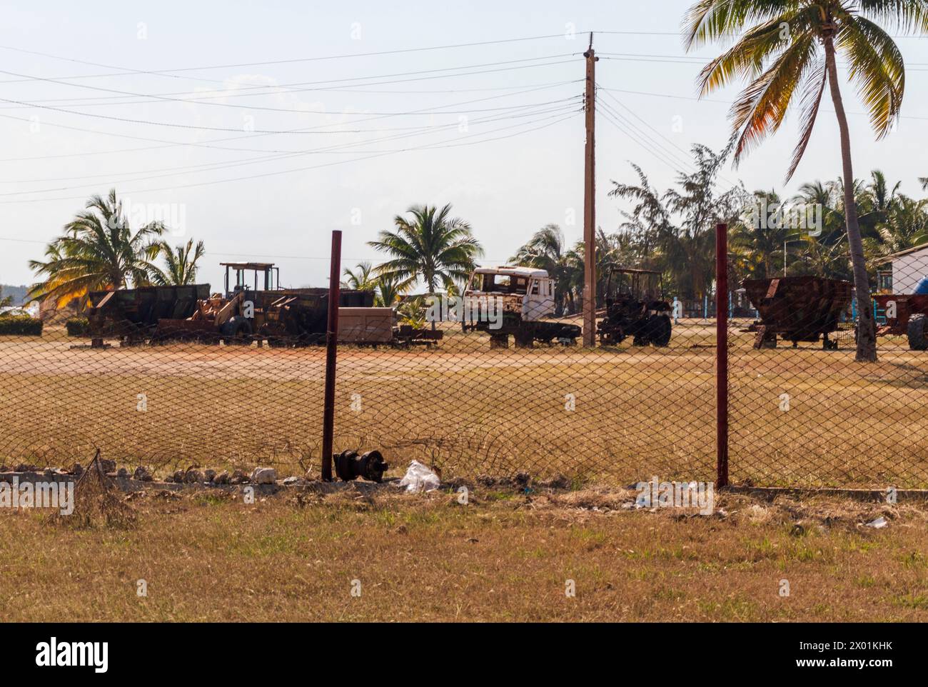 Shot of the rural village. Damaged gear, equipment and vehicles on the