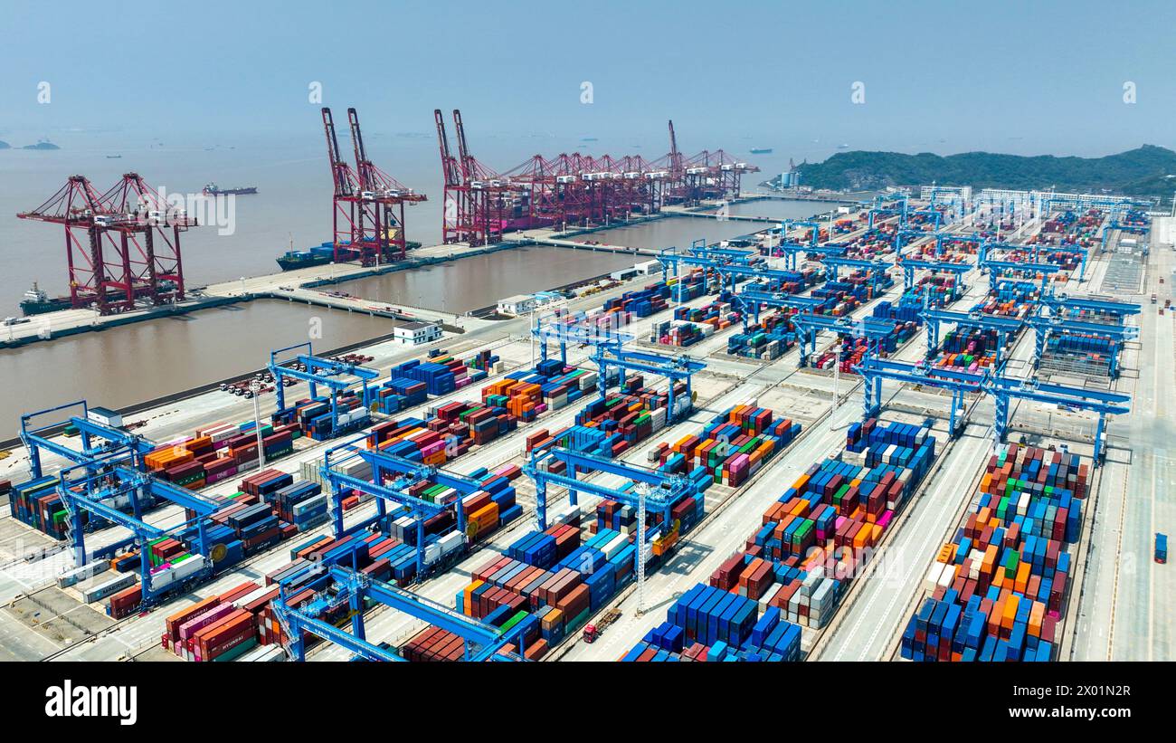 ZHOUSHAN, CHINA - APRIL 9, 2024 - Ships carry out container loading and ...