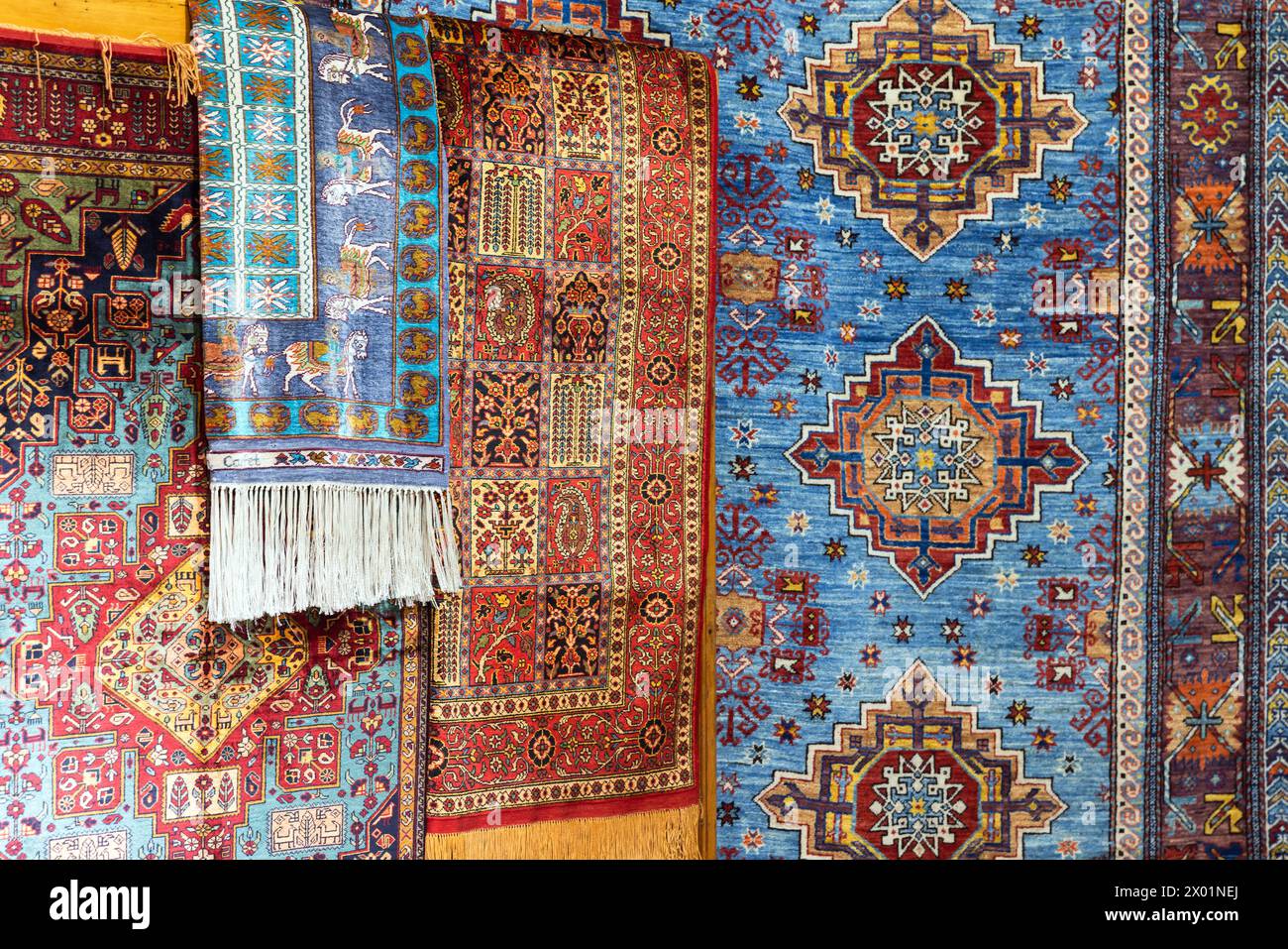Assortment of oriental silk carpets with colorful geometric patterns Stock Photo