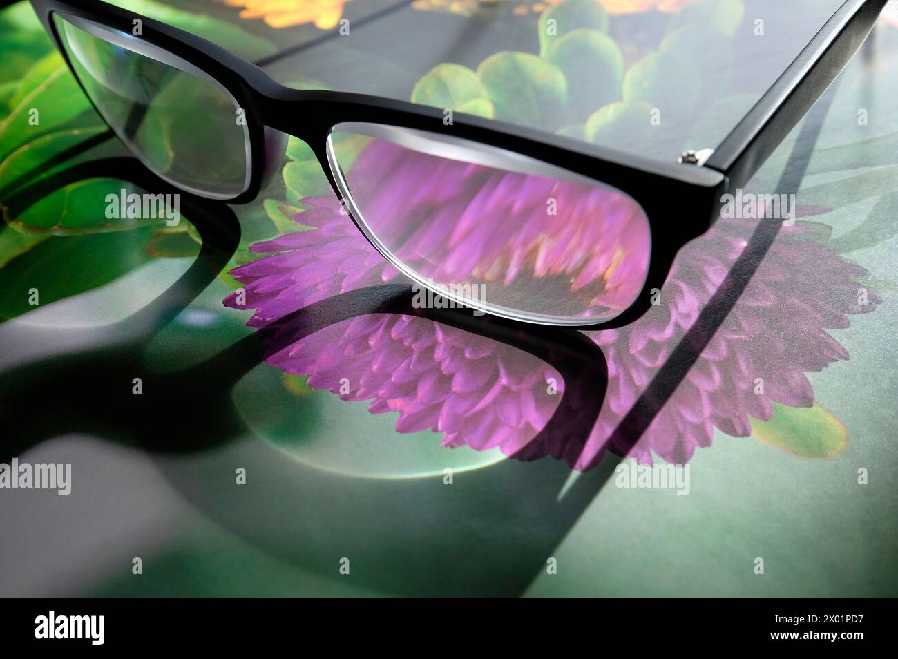 reading glasses on gardening book Stock Photo