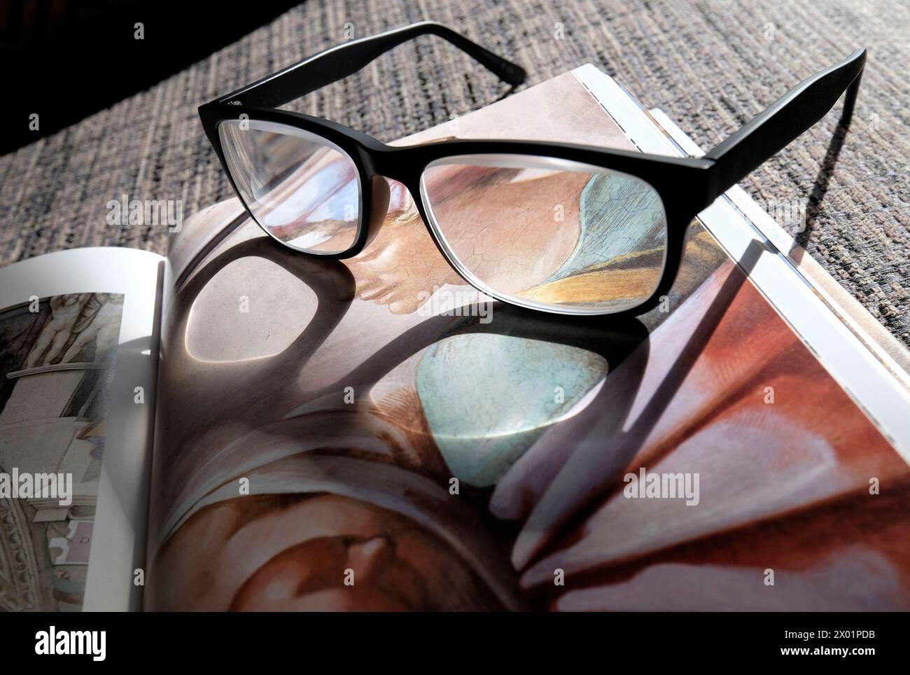 reading glasses on art history book Stock Photo