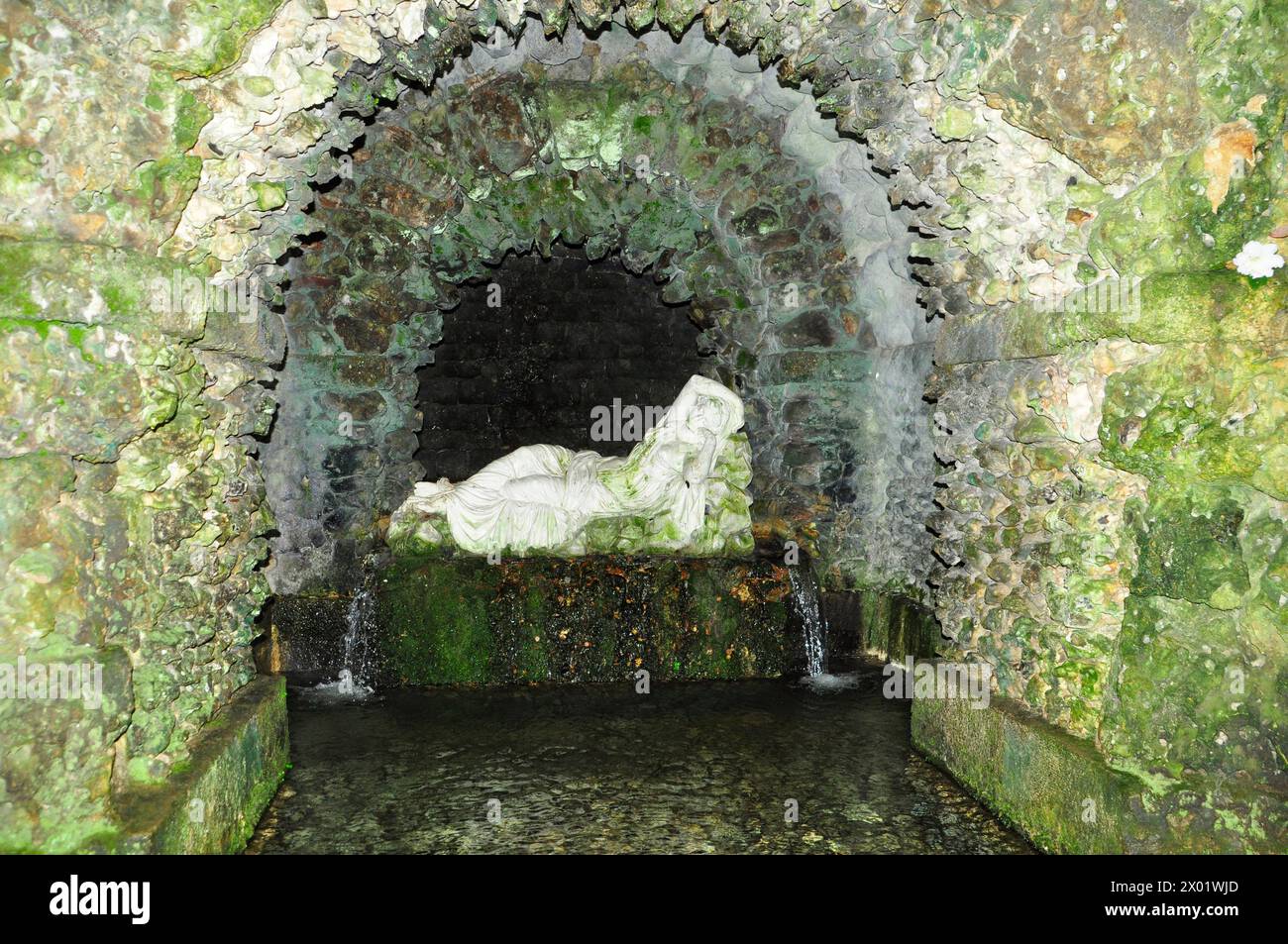 A stone sculpture of sleeping Ariadne in the Grotto beside the lake at the Stourhead gardens in Wiltshire. Stock Photo