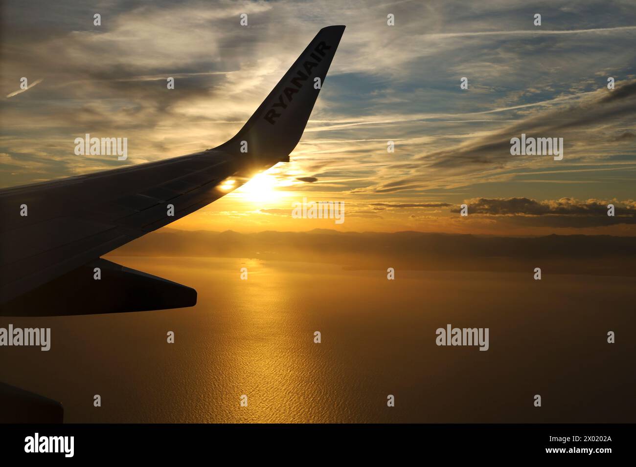 Alicante, Spain- March 28, 2024: Ryanair company plane flying over the Mediterranean coast of Alicante, Spain Stock Photo