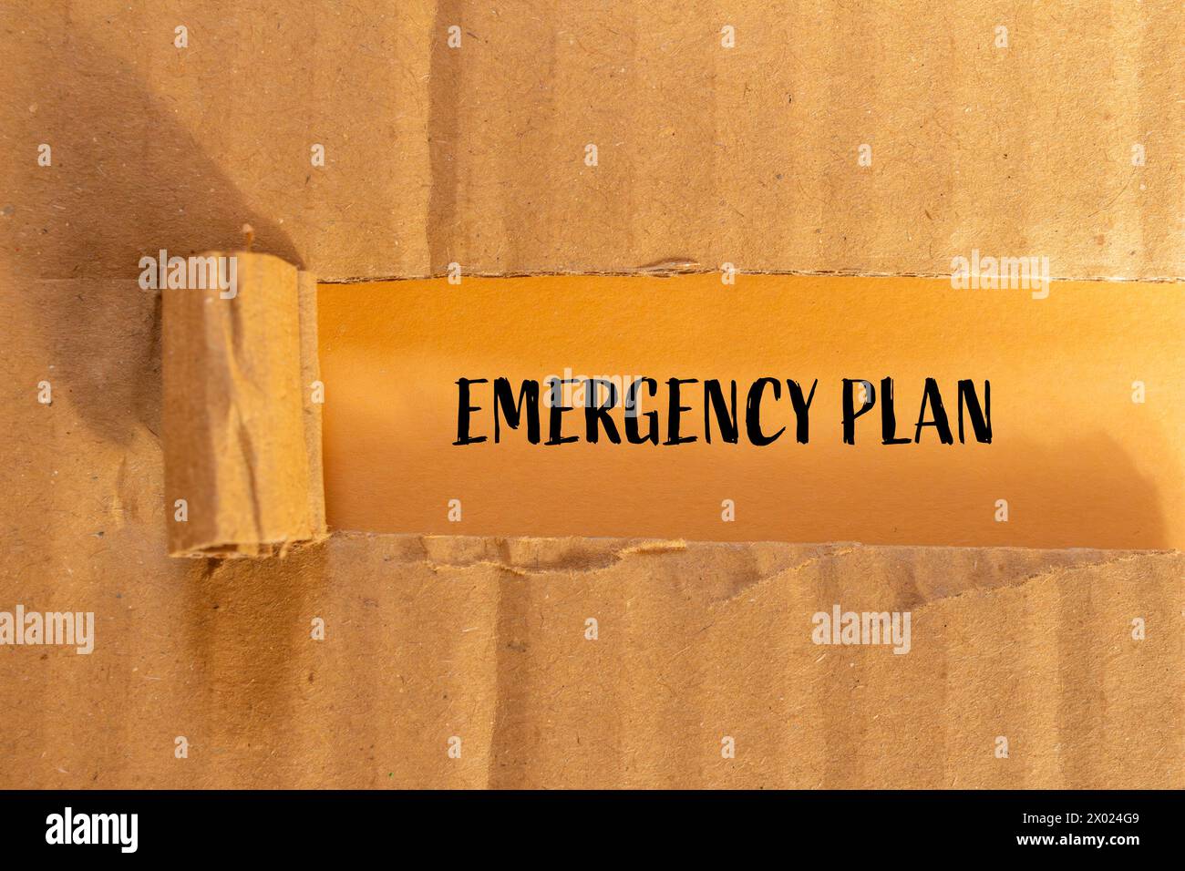 Emergency plan words written on ripped paper with orange background. Conceptual symbol. Copy space. Stock Photo