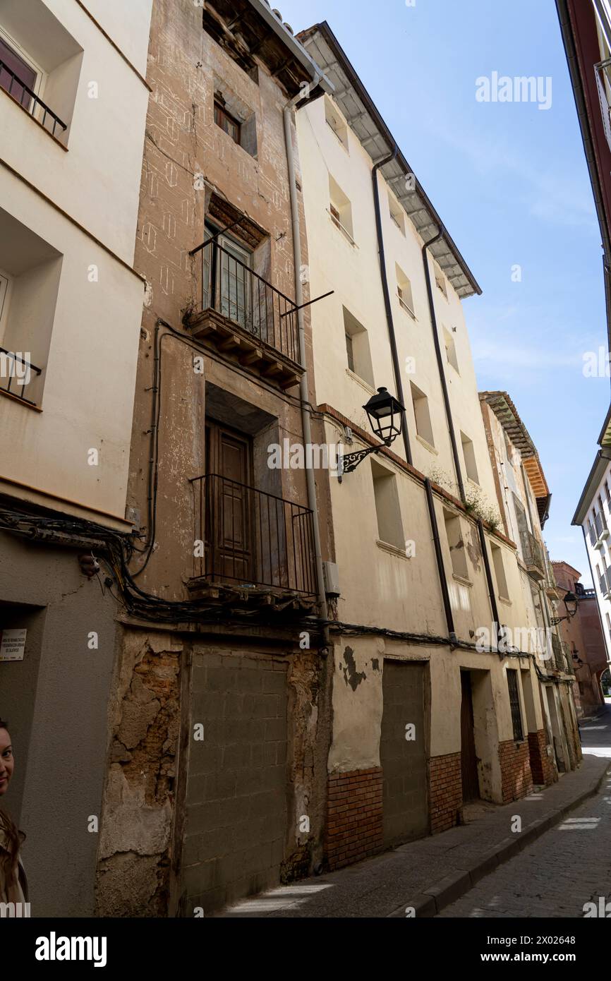 A close-up of an antique balcony with ornate railings on an aging urban building with distressed walls Stock Photo