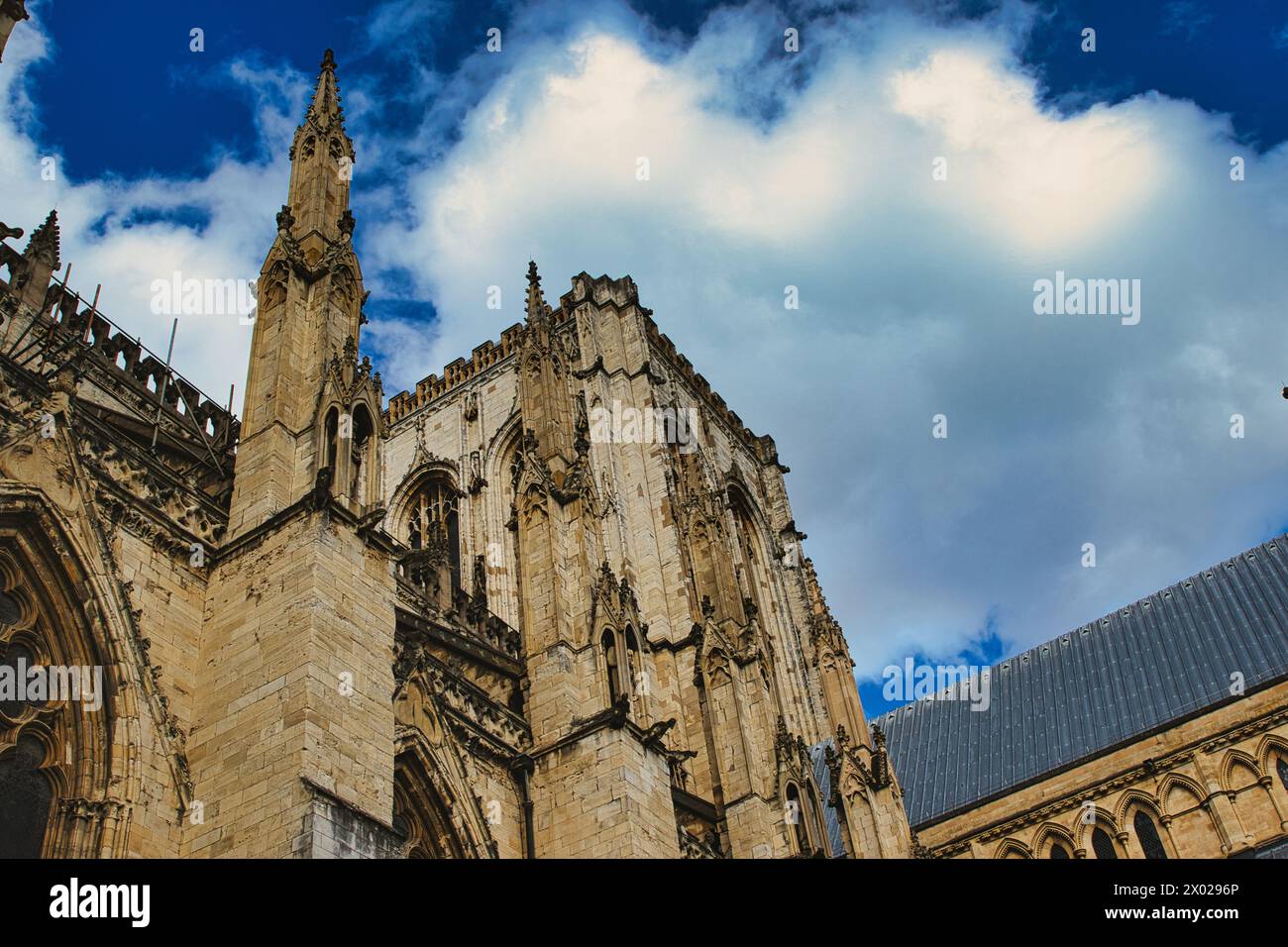 Majestic gothic cathedral facade against a dramatic sky with fluffy ...