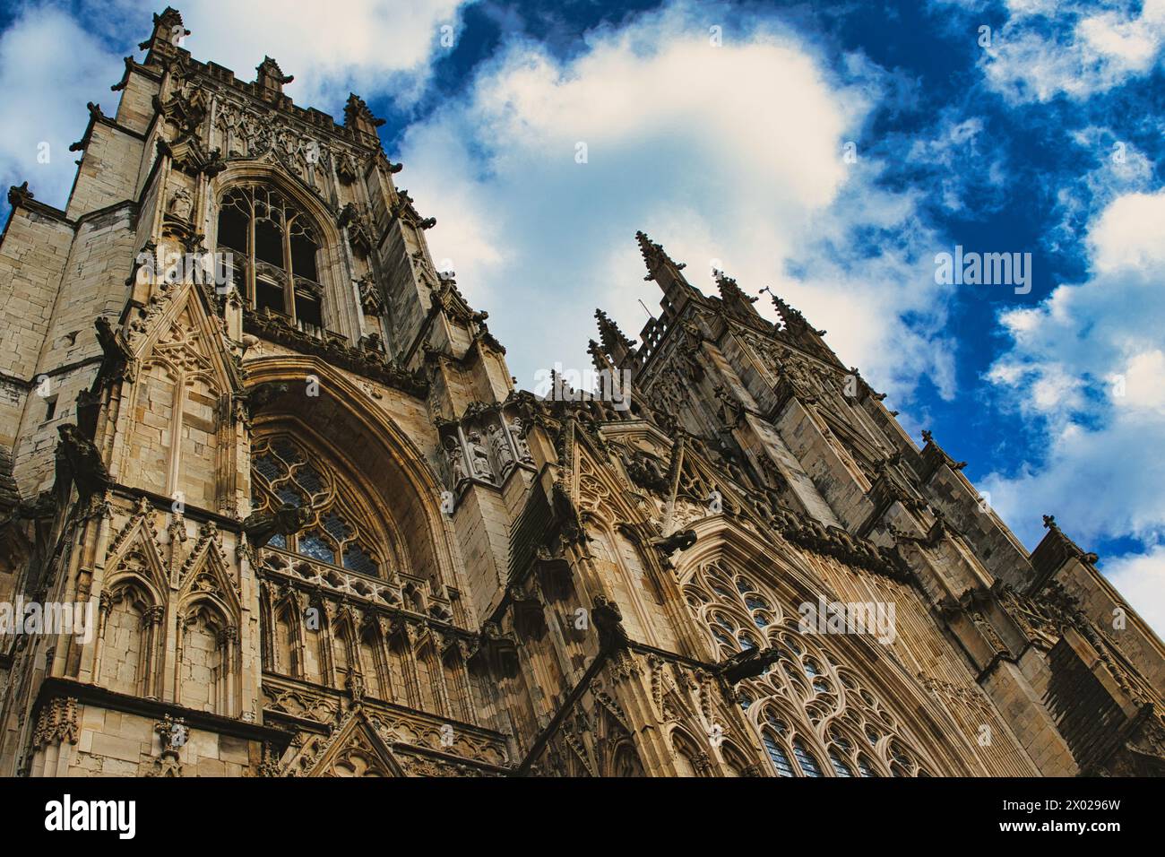 Dramatic angle of a Gothic cathedral's facade with intricate stone ...