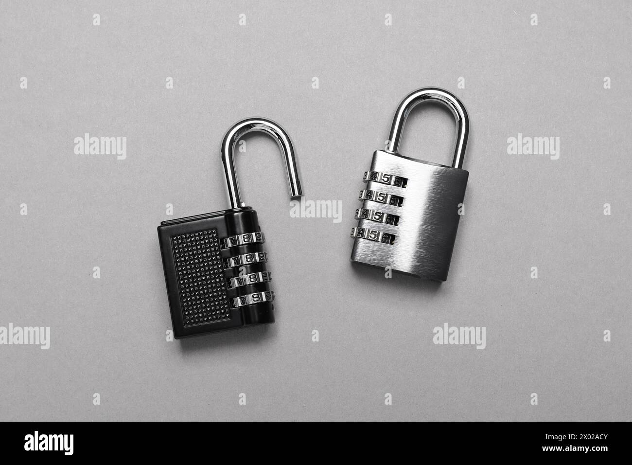 Steel combination padlocks on grey background, top view Stock Photo
