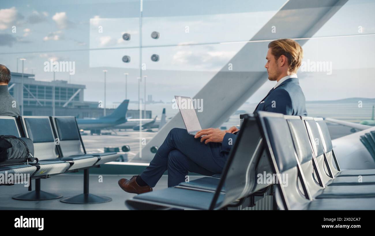 Man sitting airport uses laptop hi-res stock photography and images - Alamy