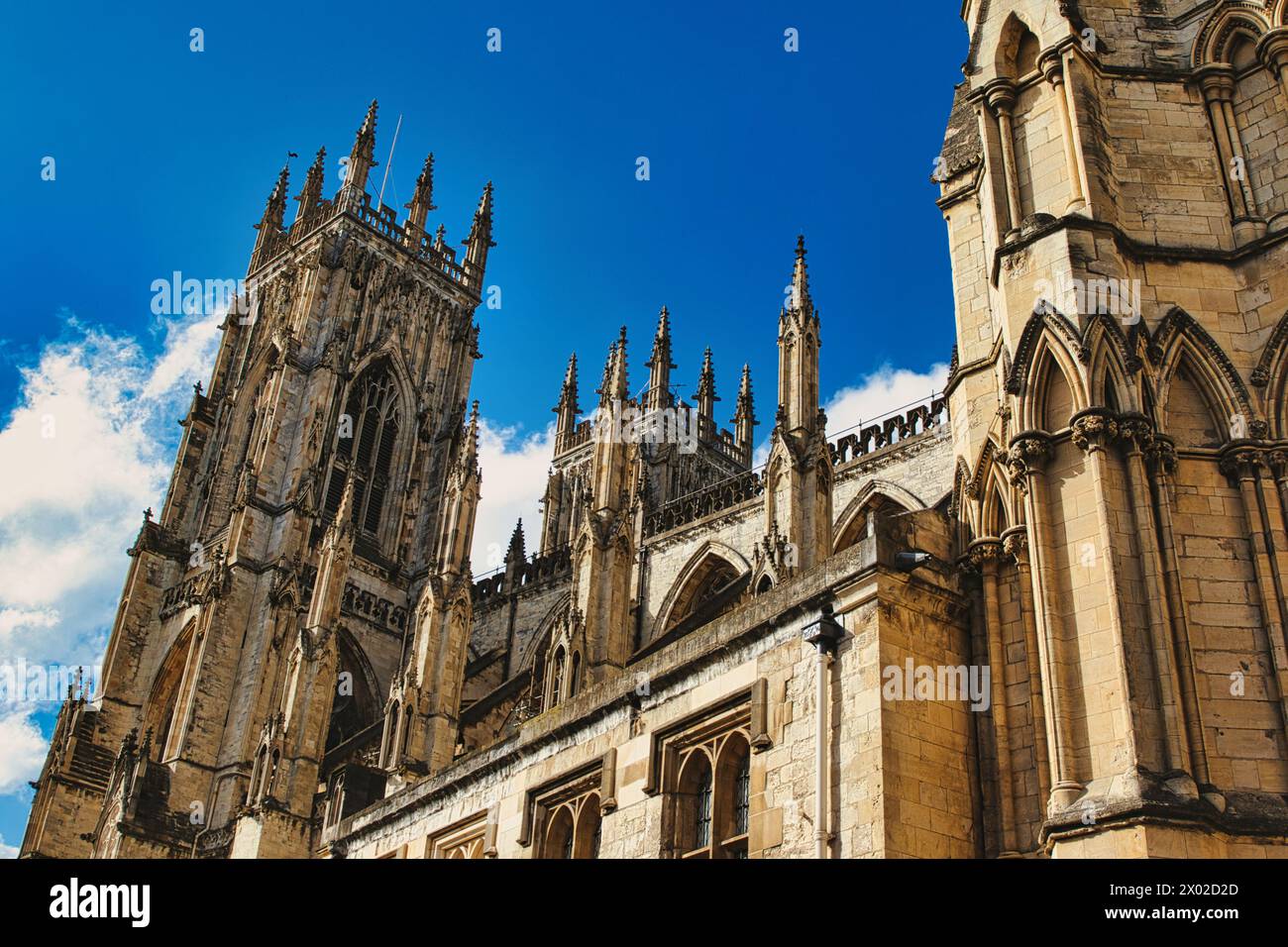 Majestic Gothic cathedral against a blue sky with clouds, showcasing ...
