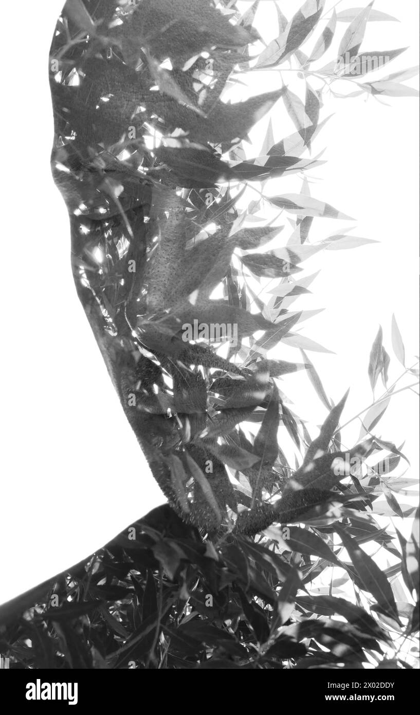 A black and white double exposure portrait of a man against a white ...
