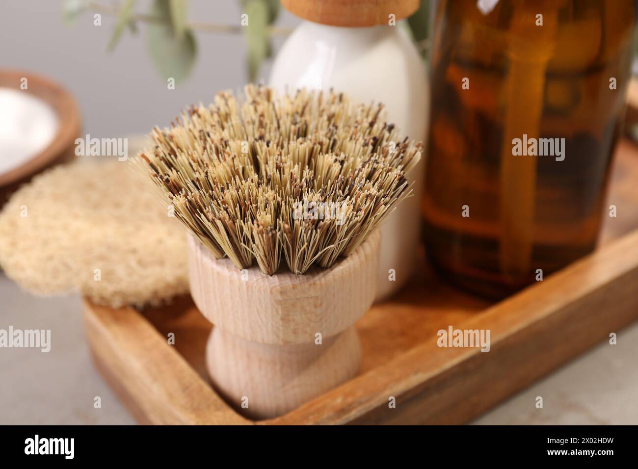 Cleaning brush, bottles and sponge on table, closeup Stock Photo