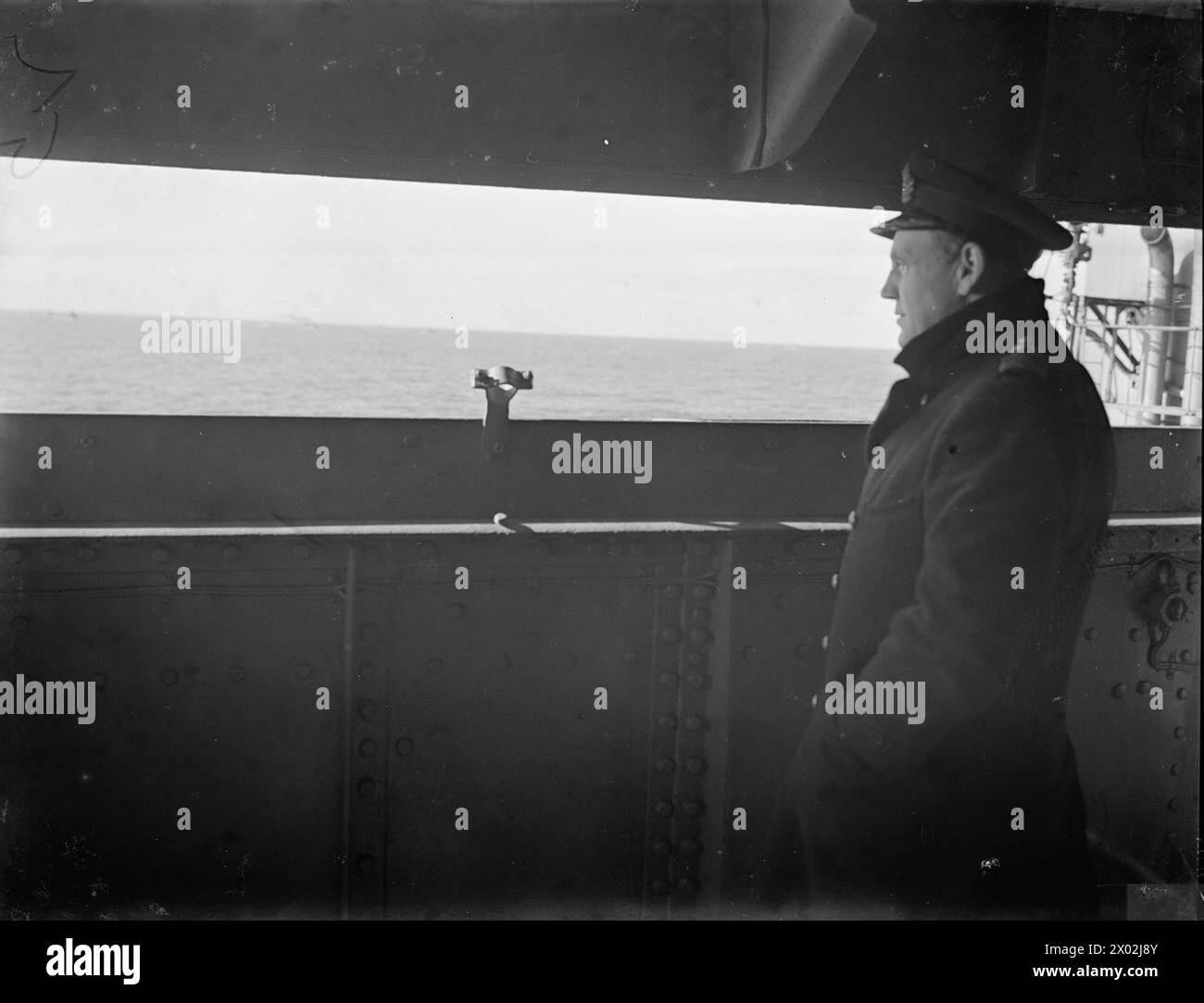 ON BOARD THE BATTLESHIP HMS RODNEY AT SEA. 1940. - Captain Dalrymple-Hamilton, RN, Captain of HMS RODNEY watching the convoy from the back of the bridge. From now on it is his responsibility to see that the convoy is not molested by the German raider Stock Photo