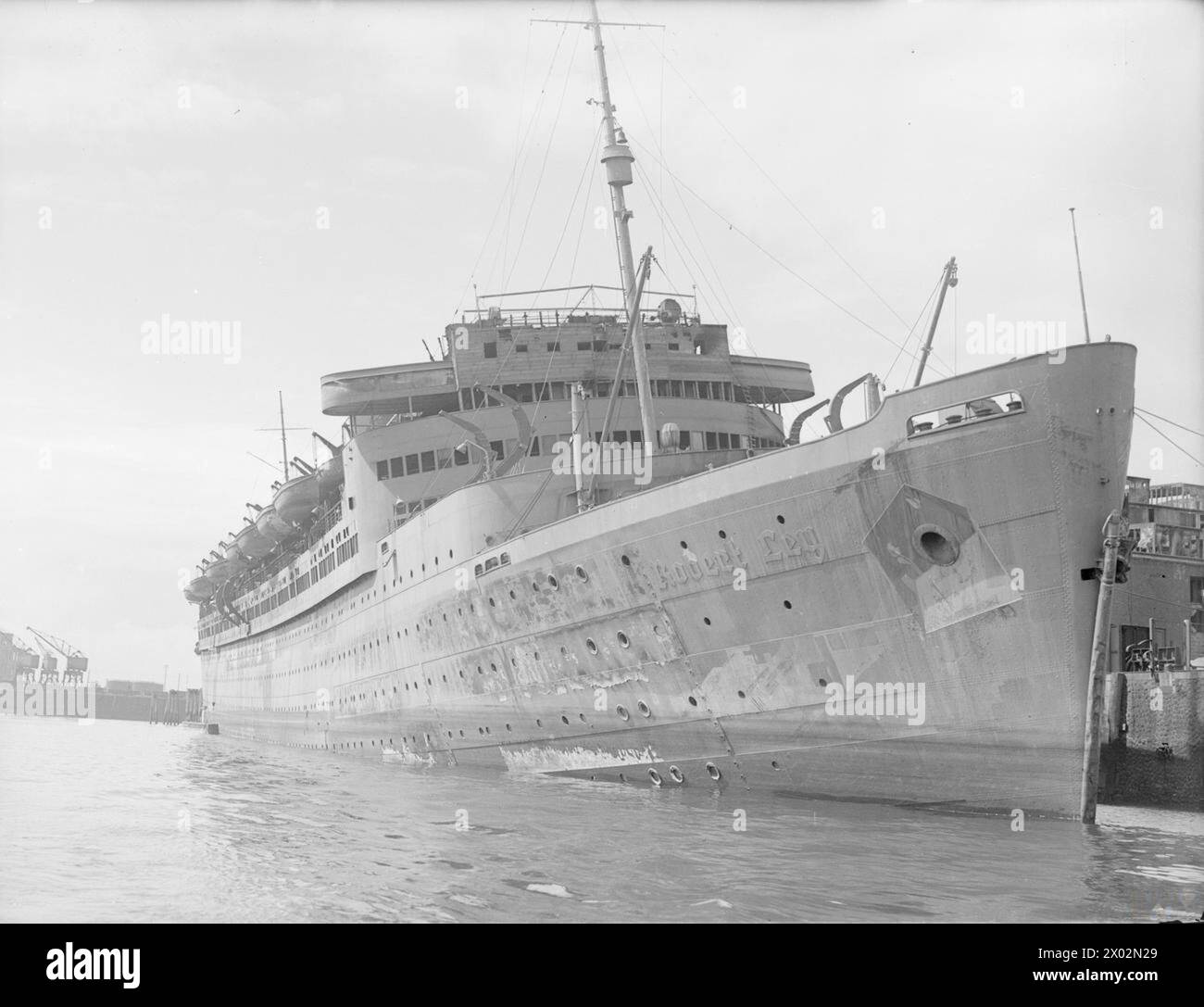 WRECKAGE IN THE BOMB-SCARRED HAMBURG DOCKS. 8 JULY 1945, WRECKED AND BURNT OUT GERMAN SHIPPING IN THE BOMB-BATTERED DOCKS AT HAMBURG. - The war scarred ROBERT LEY, 'strength through joy' ship  SS Robert Ley Stock Photo