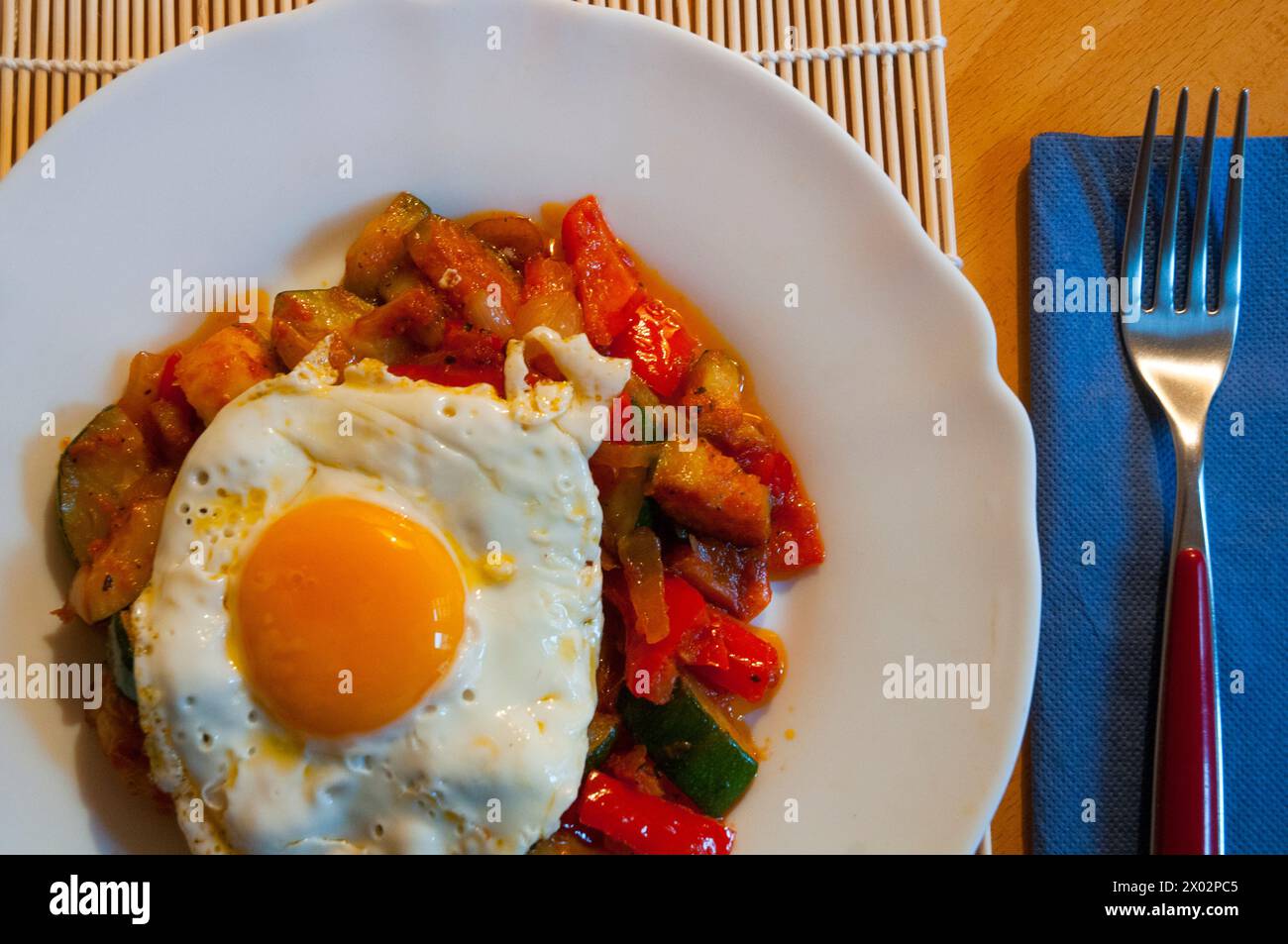 Fried egg on pisto manchego, close view. La Mancha, Spain Stock Photo ...