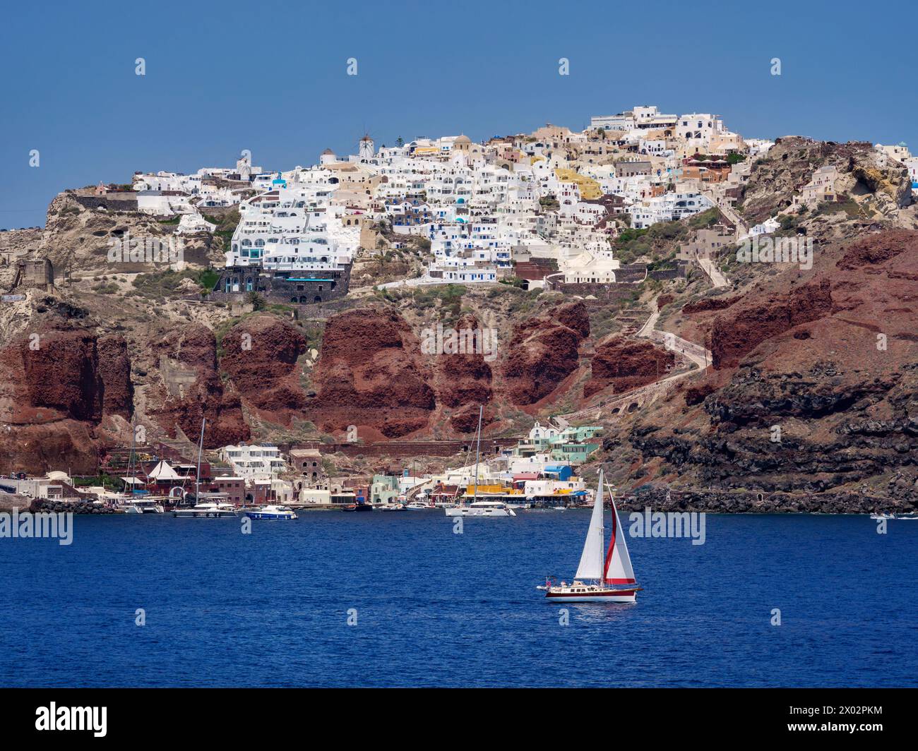 Sailboat in the caldera and Oia Village, Santorini (Thira) Island