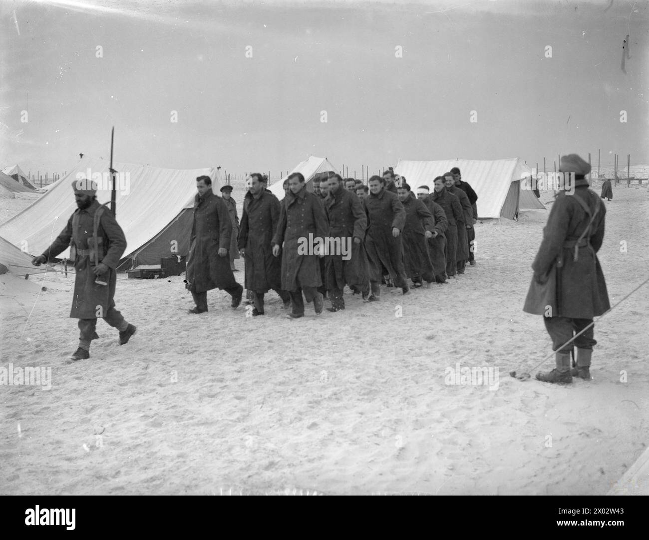 GERMAN U-BOAT PRISONERS. 30 DECEMBER 1941, AGEMI, EGYPT. - Members of a captured U-boat crew arriving at their camp under an Indian guard Stock Photo