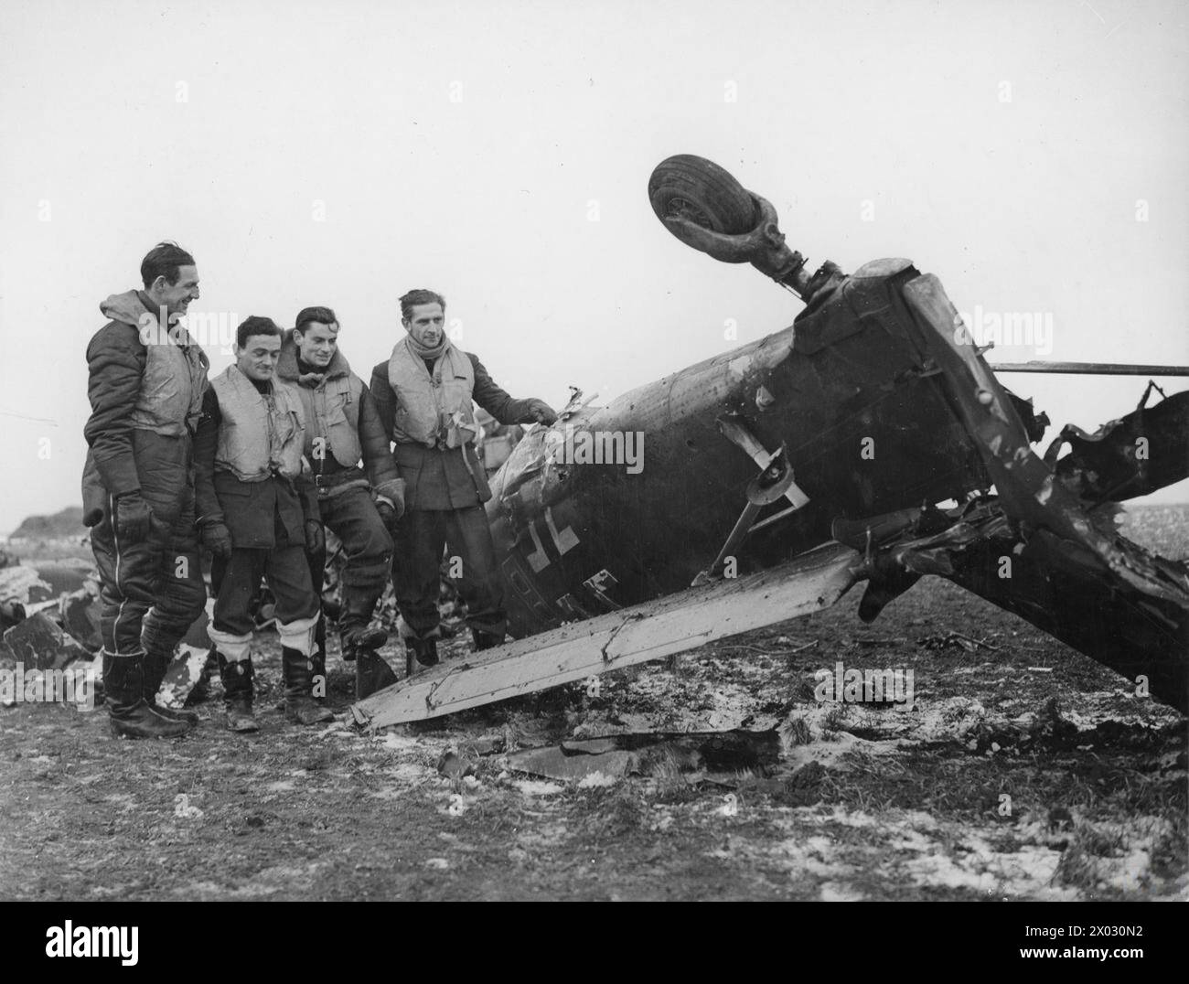 RAF FIGHTER COMMAND 1939-1945 - Spitfire pilots pose beside the wreckage of a Junkers Ju 87 Stuka, which they shot down near Manston Airfield, 5 February 1941. Airmen , L-R are Pilot Officer C.H. 'Sammy' Saunders, Sgt R. 'Titch' Havercroft, Sgt Hugh Bowen-Morris & Pilot Officer Ronald Fokes Stock Photo