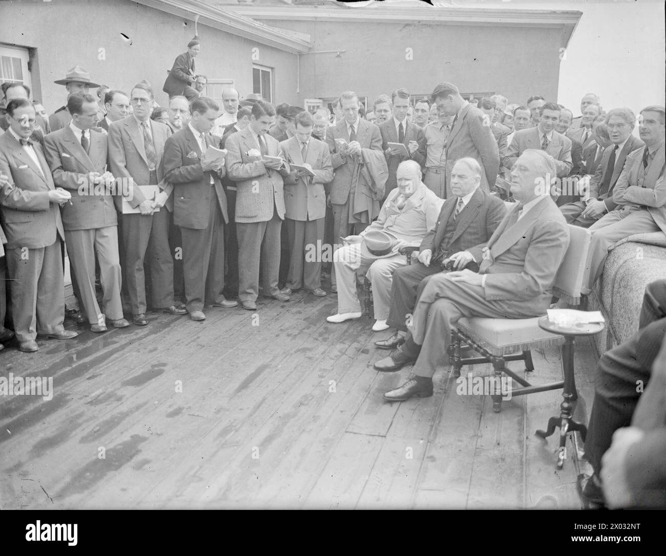 A press conference held at the Citadel on 24 August 1943 featured the Prime Minister, the President, and Mr Churchill with press representatives. Mr Eden and Mr Brendan Bracken were visible in the background. Stock Photo