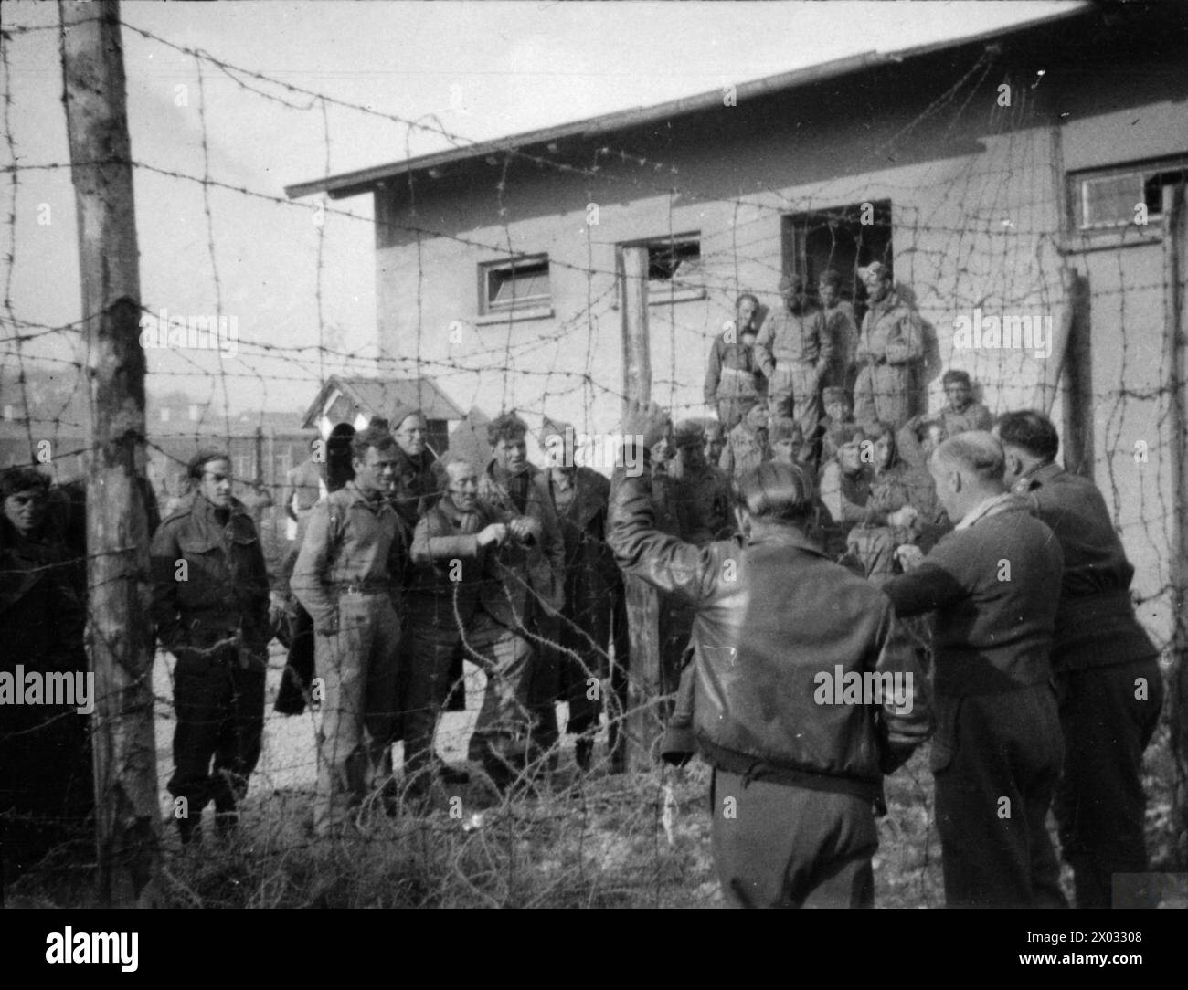 THE BRITISH ARMY IN NORTH-WEST EUROPE 1944-45 - A photograph taken covertly at Stalag VIIA at Mooseburg, showing British POWs talking to new inmates captured on the Greek island of Leros. Date unknown Stock Photo