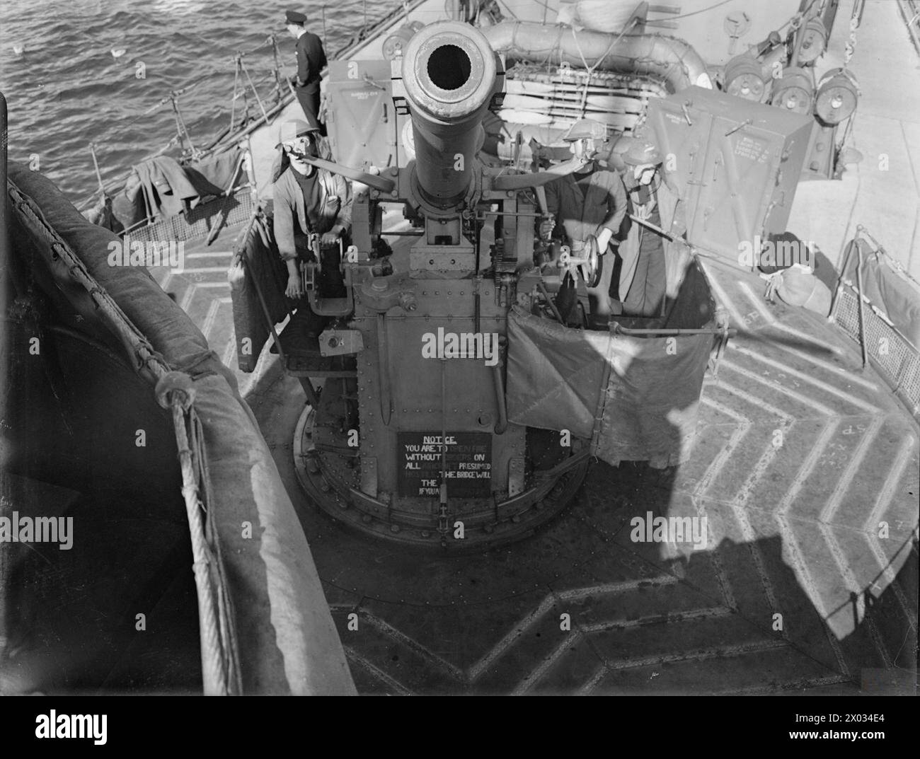 A 4-inch anti-aircraft gun aboard a destroyer in 1940 is manned by crew ...