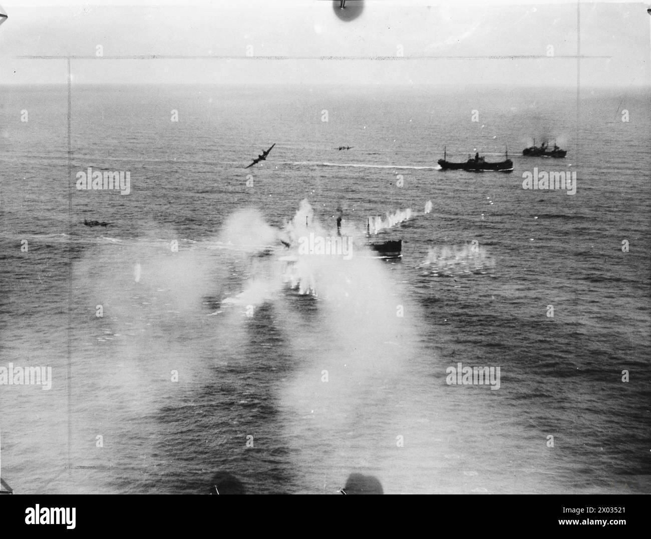 ROYAL AIR FORCE COASTAL COMMAND, 1939-1945. - Low-level oblique photograph taken during an attack on an enemy convoy north-east of Borkum off the Frisian Islands by 29 Bristol Beaufighters of the North Coates Strike Wing. Smoke rises from a 3,000-ton merchant vessel which has just been raked by cannon fire from one of the attacking Beaufighters  Royal Air Force, Flying Training School, 16 (Polish), Hucknall Stock Photo