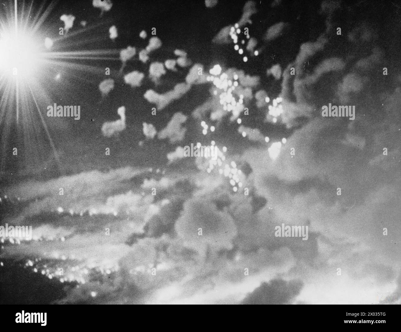 RAF Bomber Command aircraft from Nos. 1, 6, and 8 Groups conduct an area-bombing raid on Pforzheim, Germany, 1942-1945, captured by the RAF Film Production Unit. Stock Photo