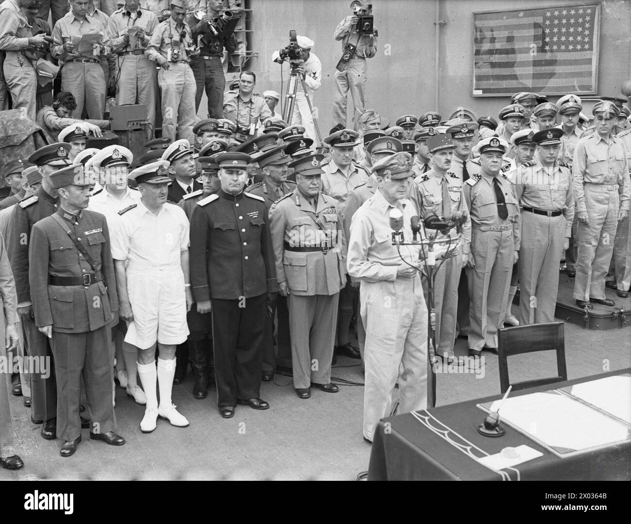 JAPANESE SURRENDER AT TOKYO BAY, 2 SEPTEMBER 1945 - General of the Army, Douglas MacArthur reads the surrender terms to the Japanese representatives on board USS MISSOURI in Tokyo Bay  MacArthur, Douglas, United States Navy, USS Missouri, Battleship, (1944) Stock Photo