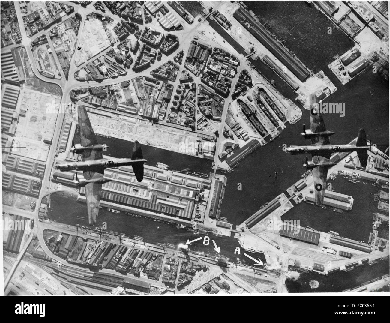 ROYAL AIR FORCE BOMBER COMMAND, 1942-1945. - Annotated vertical aerial photograph taken during a daylight attack by 12 Douglas Boston Mark IIIs of No. 226 Squadron RAF on shipping in le Havre, France. Two Bostons fly over the docks as bombs explode on the dock gates ( 'A'), and also among barges in the Bassin Vauban ('B')  Royal Air Force, Group, 226, Royal Air Force, 2 Group Stock Photo