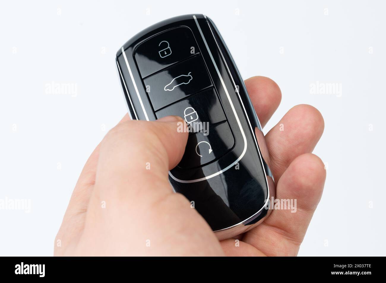 Lock car with key  in hand isolated close up view Stock Photo