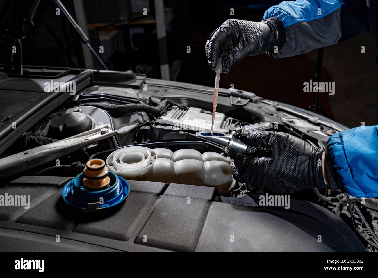 Witness the precision of a mechanic's gloved hands as they carefully