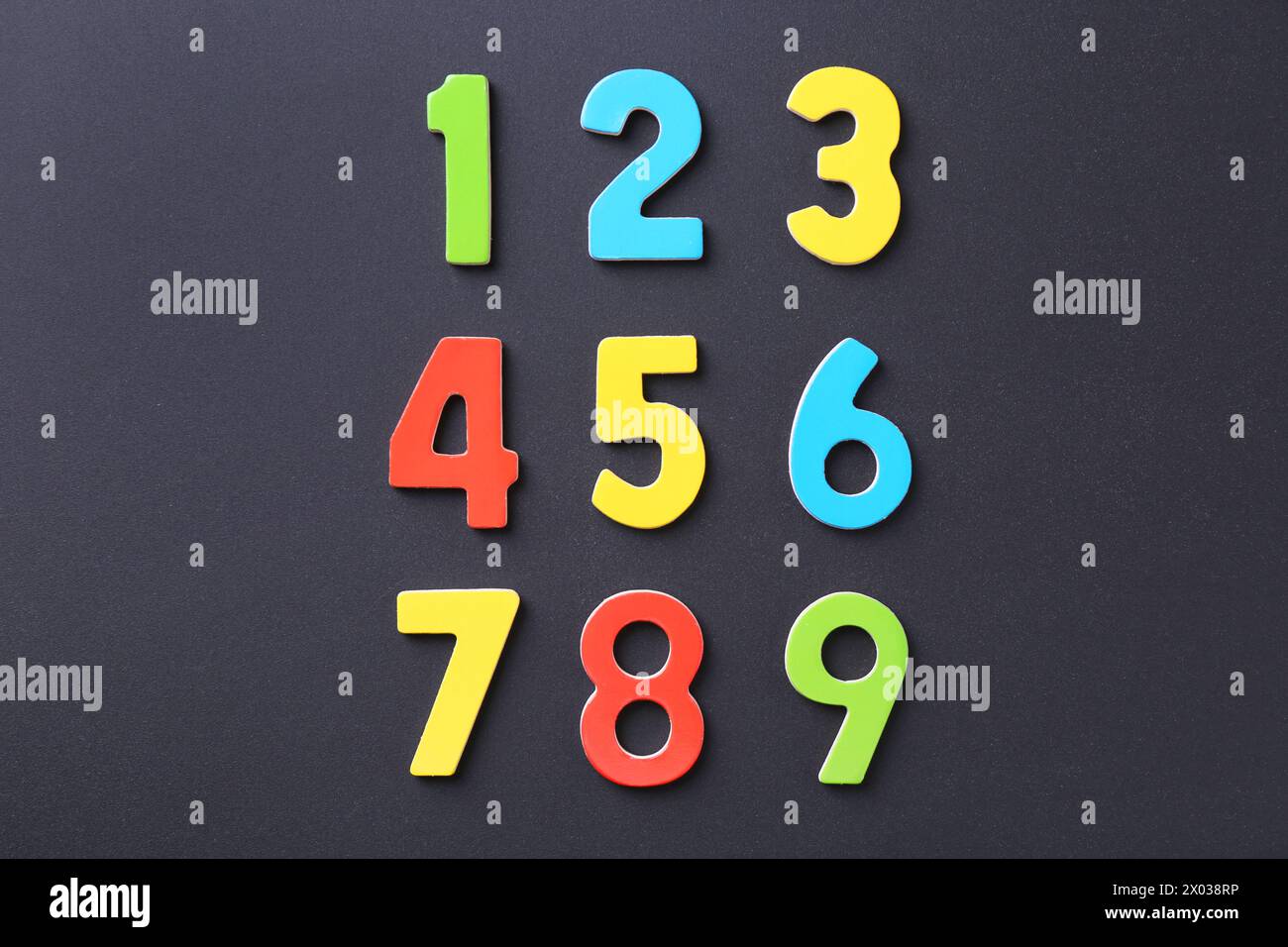 Colorful numbers on black background, flat lay Stock Photo - Alamy