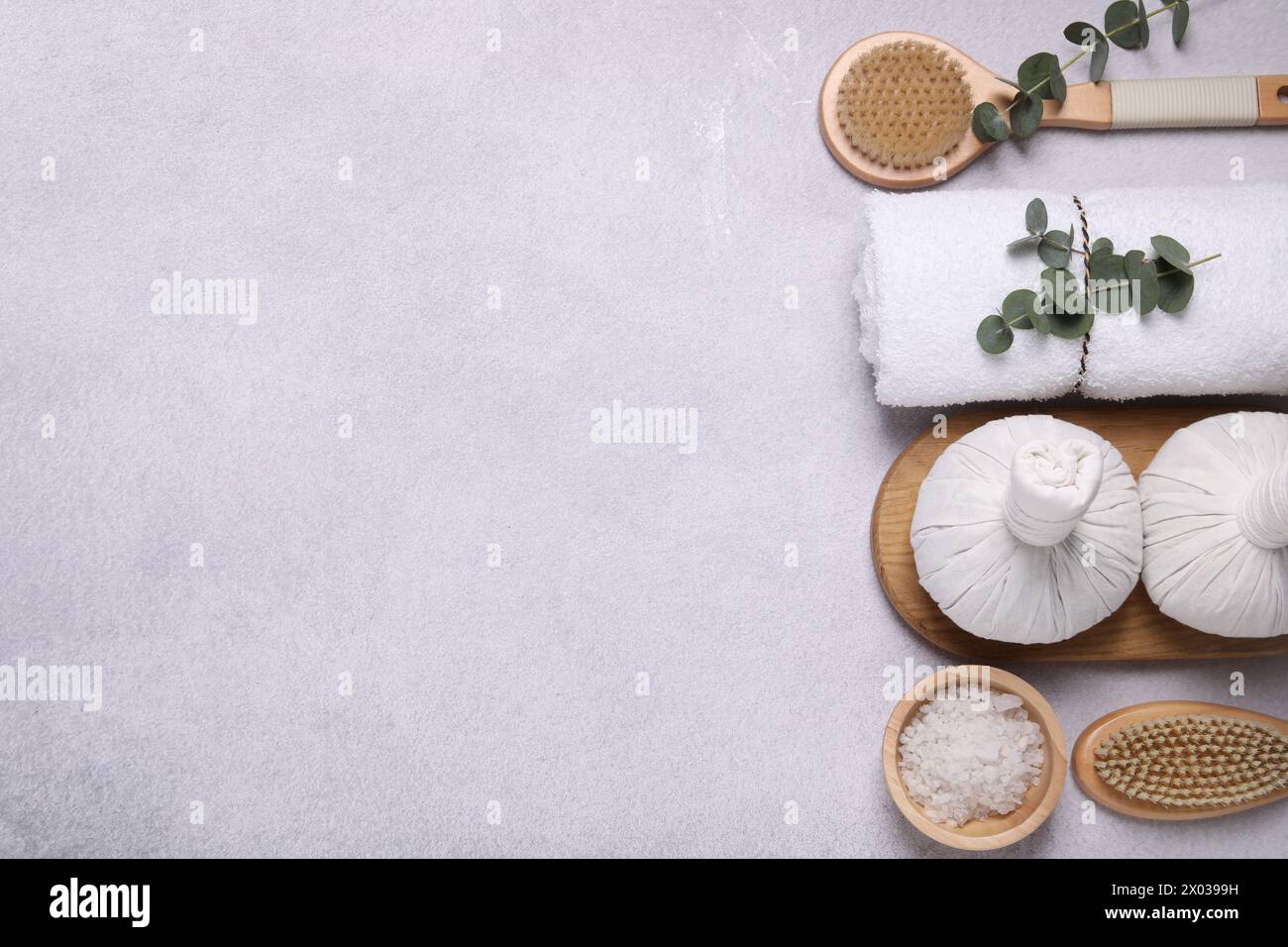 Flat lay composition with spa products and eucalyptus branches on grey ...