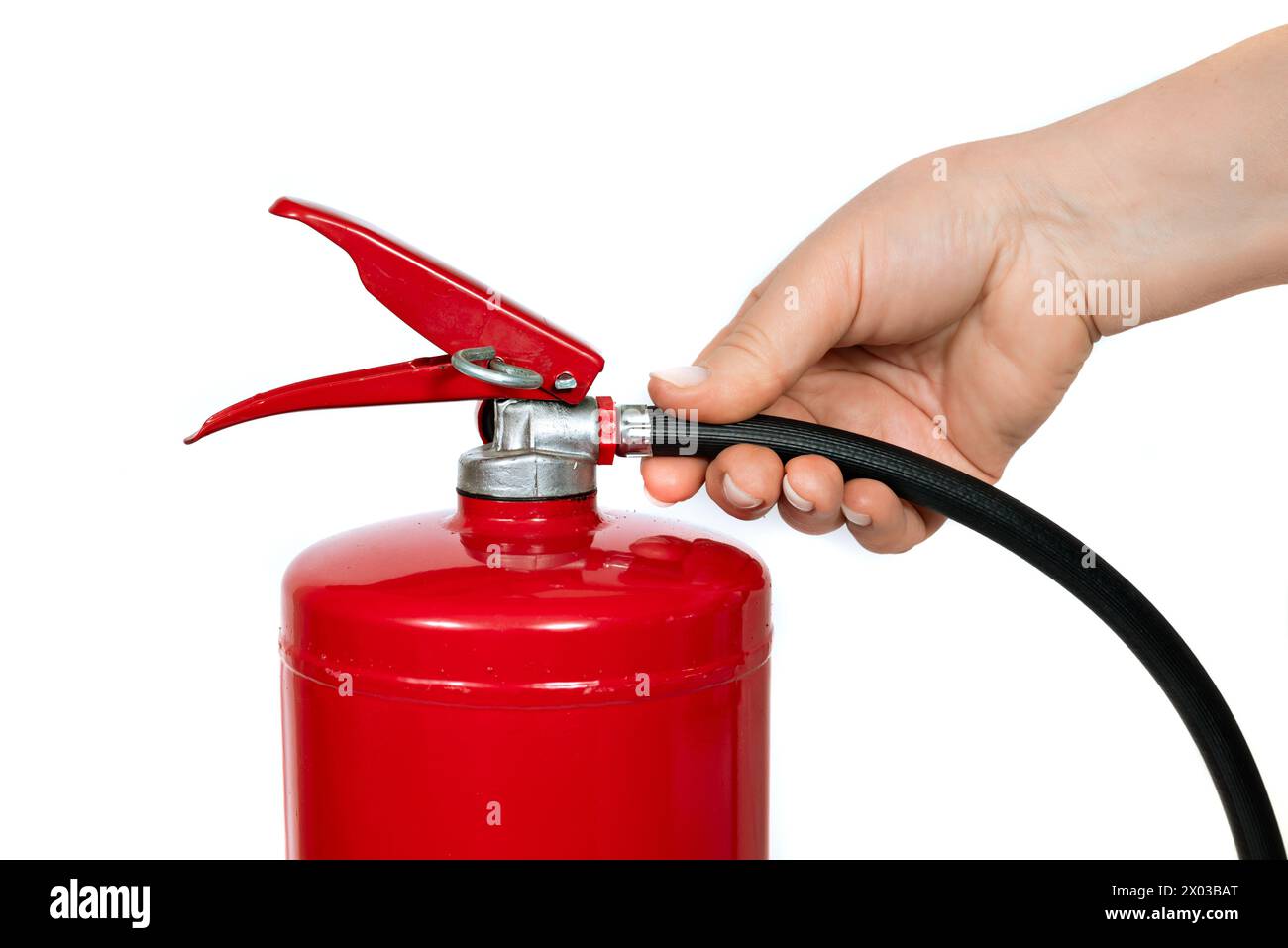 A red cylinder fire extinguisher with a black hose, contrasting on a white background. The extinguisher contains a pressurized gas and is commonly use Stock Photo